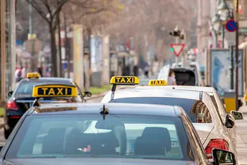 Cab rank in Vienna on the Ringstrasse with several cabs with signs (black with yellow lettering)