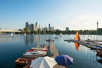 Summer day on the Old Danube, boats in the water, Vienna skyline in the background