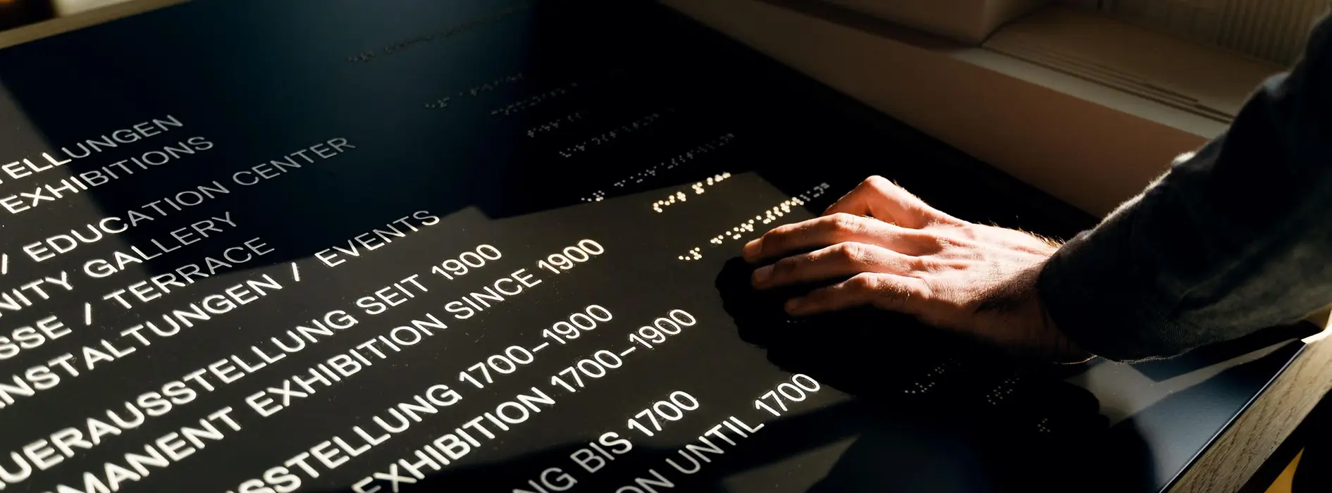 Blind person feels lettering in Braille