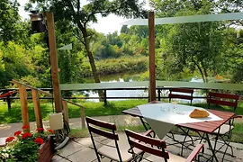 View of the restaurant Das Chadim and a bathing pond from above