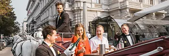 People riding in a horse-drawn carriage in Vienna