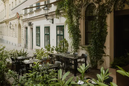 Outdoor dining area at TIAN Bistro restaurant on Spittelberg